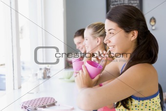 A young woman drinking a milkshake in a cafe