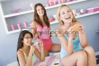 Three young women in their underwear having a tea party