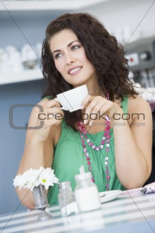 A young woman drinking tea in a cafe