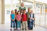 Kindergarten teacher standing with children in corridor