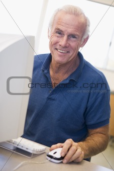 Mature male student learning computer skills