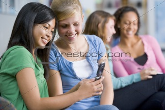 Teenage girls looking at a mobile phone