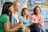 Teenage girls enjoying healthy lunches together