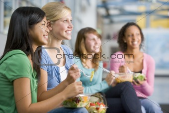 Teenage girls enjoying healthy lunches together