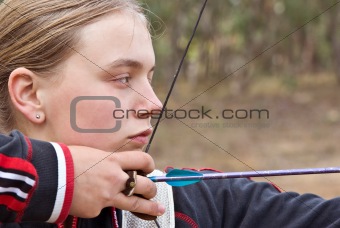 teenage girl doing archery