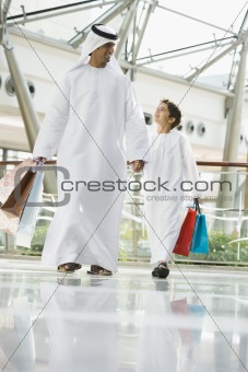 A Middle Eastern man and his son in a shopping mall