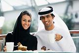 A Middle Eastern couple enjoying a meal in a restaurant