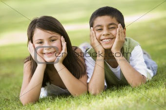 Two children relaxing in park