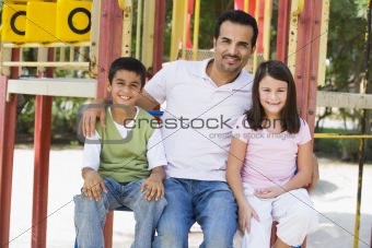Father with children in playground
