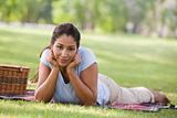 Woman relaxing in park with picnic