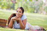 Woman relaxing in park with picnic