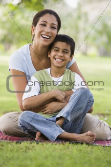 Mother and son relaxing in park
