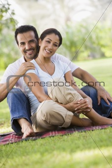 Couple relaxing in park together