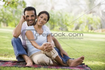Couple relaxing in park