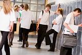 High school students by lockers in the school corridor