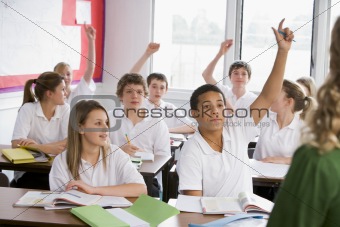 High school students answering a question in class