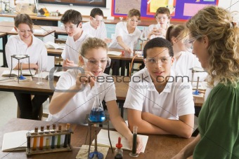 Schoolchildren and teacher in science class