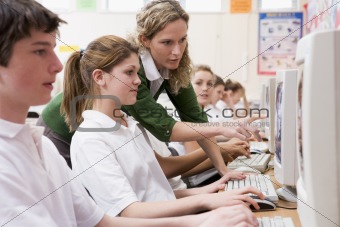 Row of schoolchildren studying in front of a computer