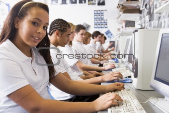 Row of schoolchildren studying in front of a computer