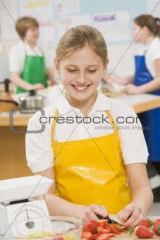 Schoolgirl at school in a cooking class