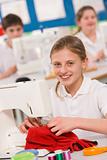 Schoolgirl using a sewing machine in sewing class