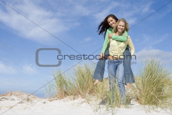 Two young women having fun in dunes