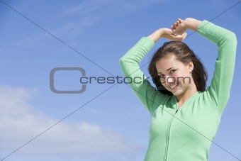 Young woman stretching outside