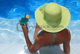 Woman lying in blue pool
