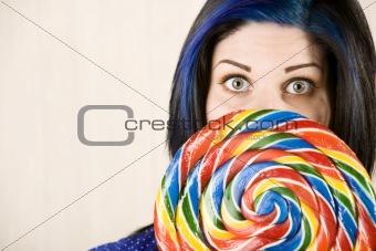 Pretty woman behind a lollipop