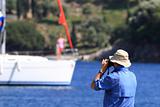Man taking photos of a yachts in bay.