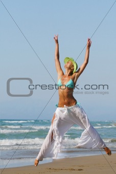 woman standing on shoreline at the beach in Greece