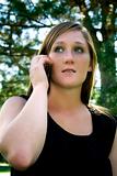 Beautiful Girl in the Park in a Black Dress Talking on the Phone