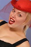 excited blond girl in red hat