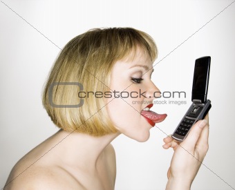 Woman licking phone.