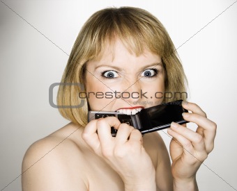 Woman biting phone.