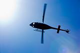Black helicopter flying overhead.