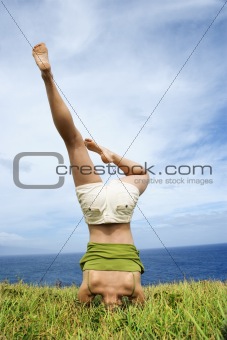 Woman doing headstand.