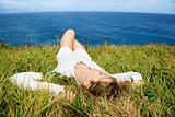 Woman relaxing in grass.