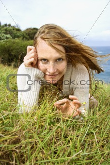 Woman lying in grass.