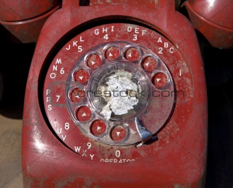 Old red rotary phone.