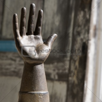 Old metal hand statuette.