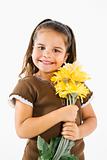 Little smiling hispanic girl with flowers.