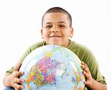 Smiling young hispanic boy with globe