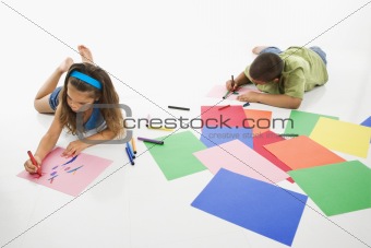 Hispanic boy and girl coloring.