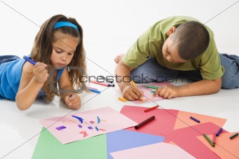 Hispanic boy and girl coloring.