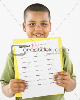 Smiling hispanic boy holding homework.