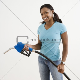 Woman with gas nozzle.