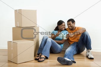 Portrait of couple with boxes.