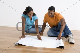 Couple looking at blueprints.