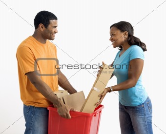 Man and woman recycling.